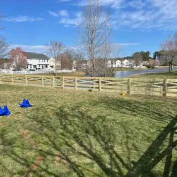 Wood fence installation near pond