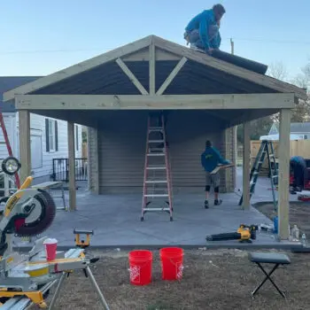 People building backyard deck pergola