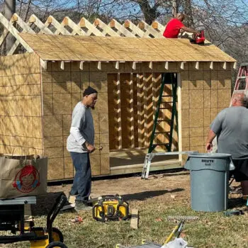 Workers building wood structure framing