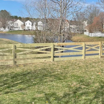 wood fence installation near pond